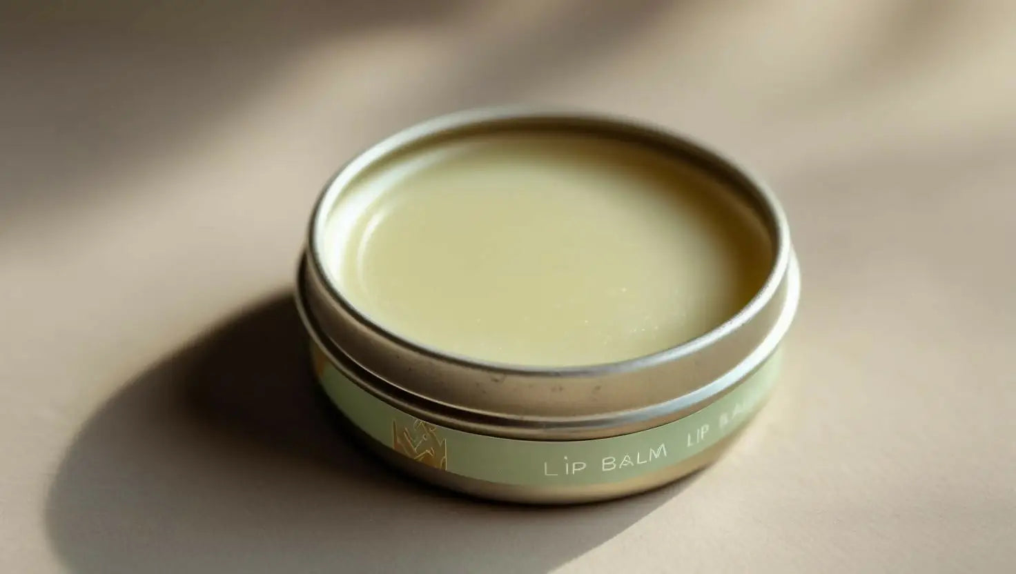 Open tin of light green 1 Ounce Lip Balm with smooth texture and natural appearance