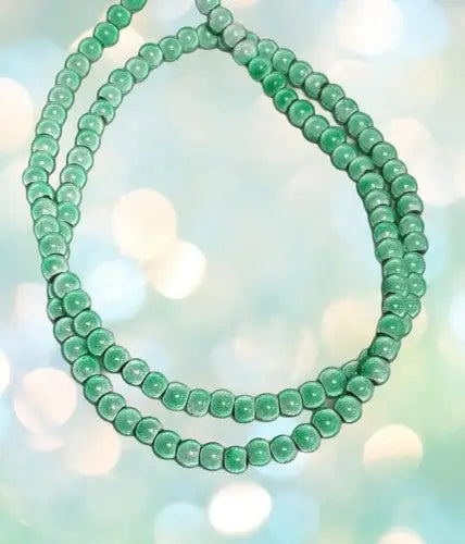 Polished mint green 6mm jade beads with original gloss on a strand for jewelry making