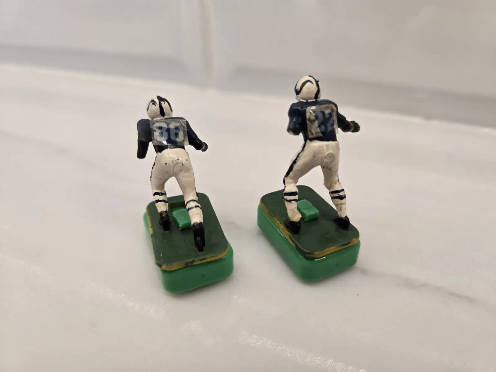 Two vintage Indianapolis Colts electronic football figures in damaged condition
