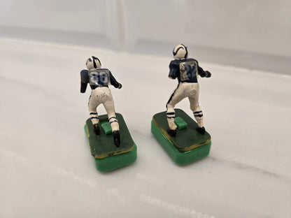 Two vintage Indianapolis Colts electronic football figures in damaged condition