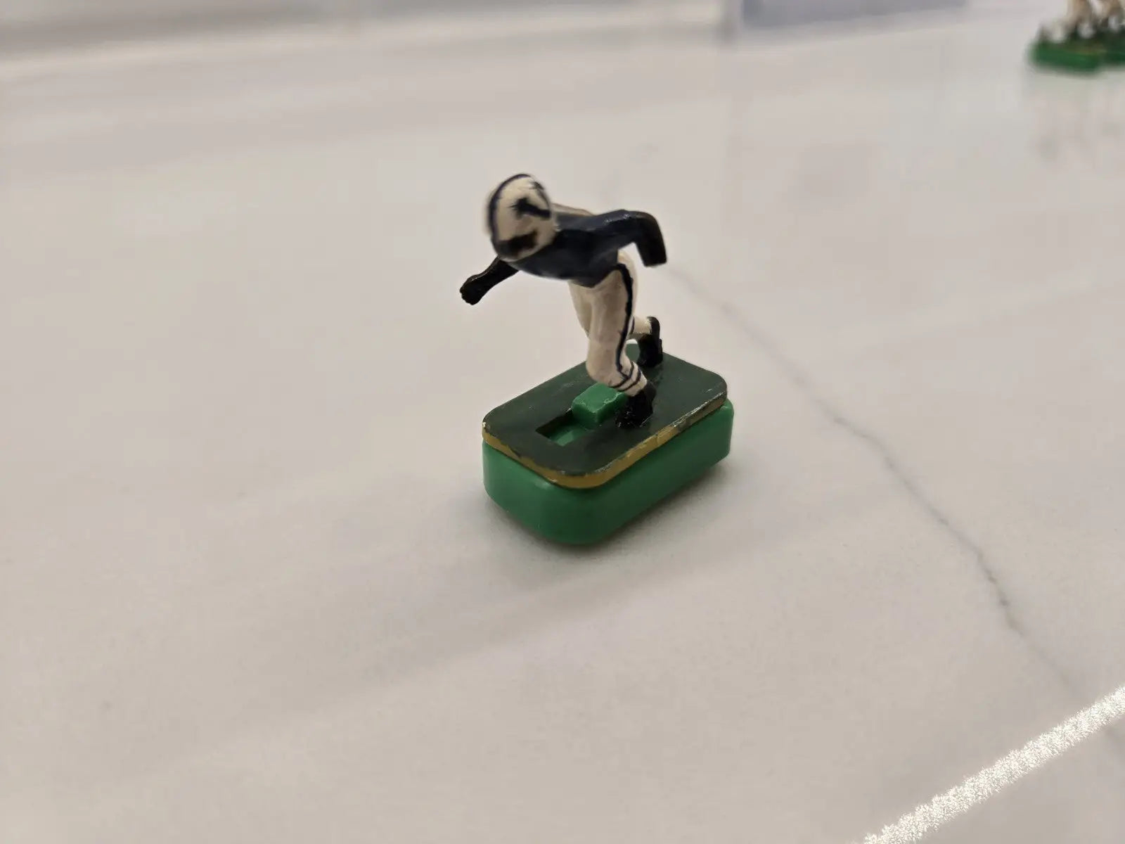 Vintage green Indianapolis Colts electronic football player figurine in navy blue and cream uniform