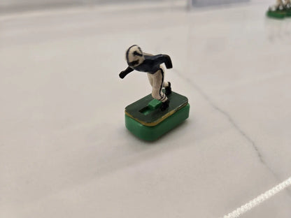 Vintage green Indianapolis Colts electronic football player figurine in navy blue and cream uniform