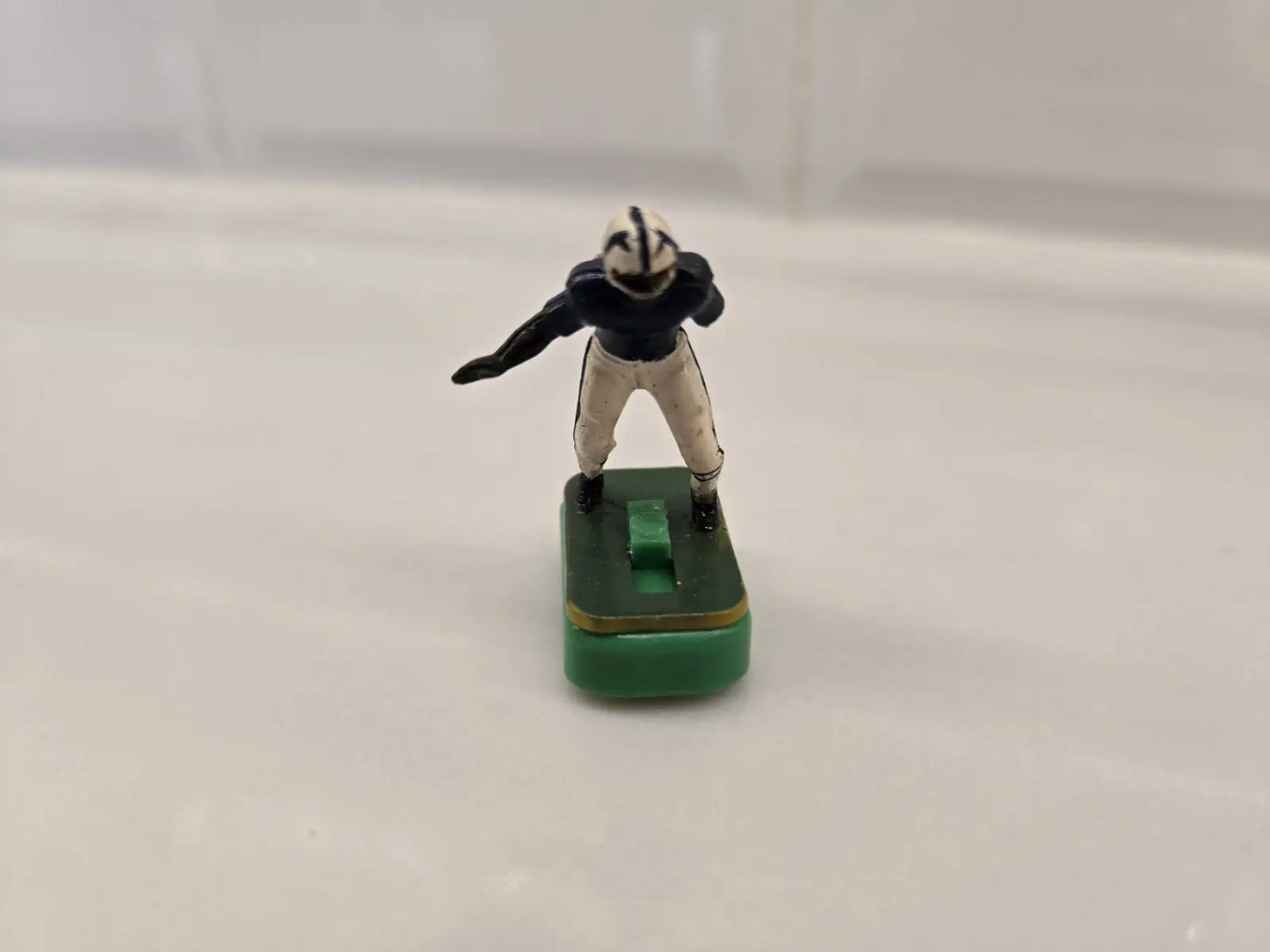 Toy football player on green base from Indianapolis Colts Electronic Football set