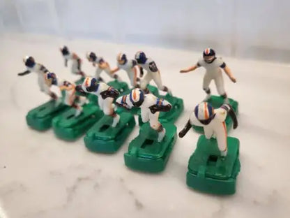 Vintage Denver Broncos electronic football game figures in white uniforms with stands