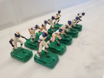 Electric football figures of Denver Broncos electronic players with stands in white uniforms