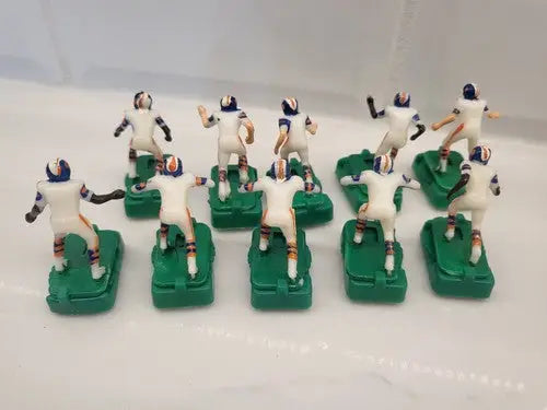 Vintage Denver Broncos electronic football game figures in white uniforms with stands