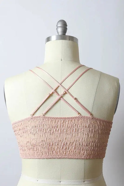 Light pink smocked bandeau top with criss-cross spaghetti straps, crochet daisy longline bralette
