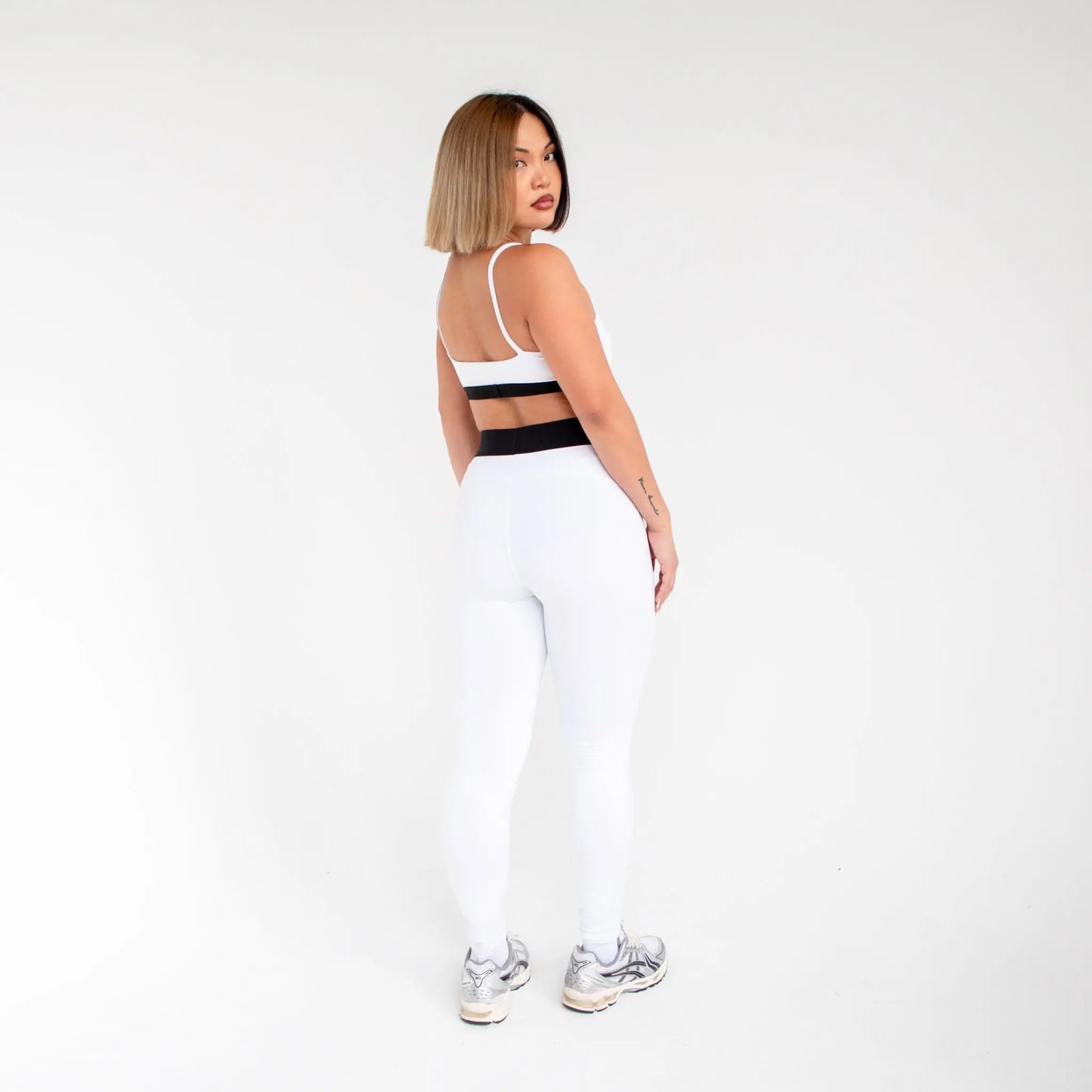 White athletic set with black waistband and straps, stretchy for comfort, info otlapparel