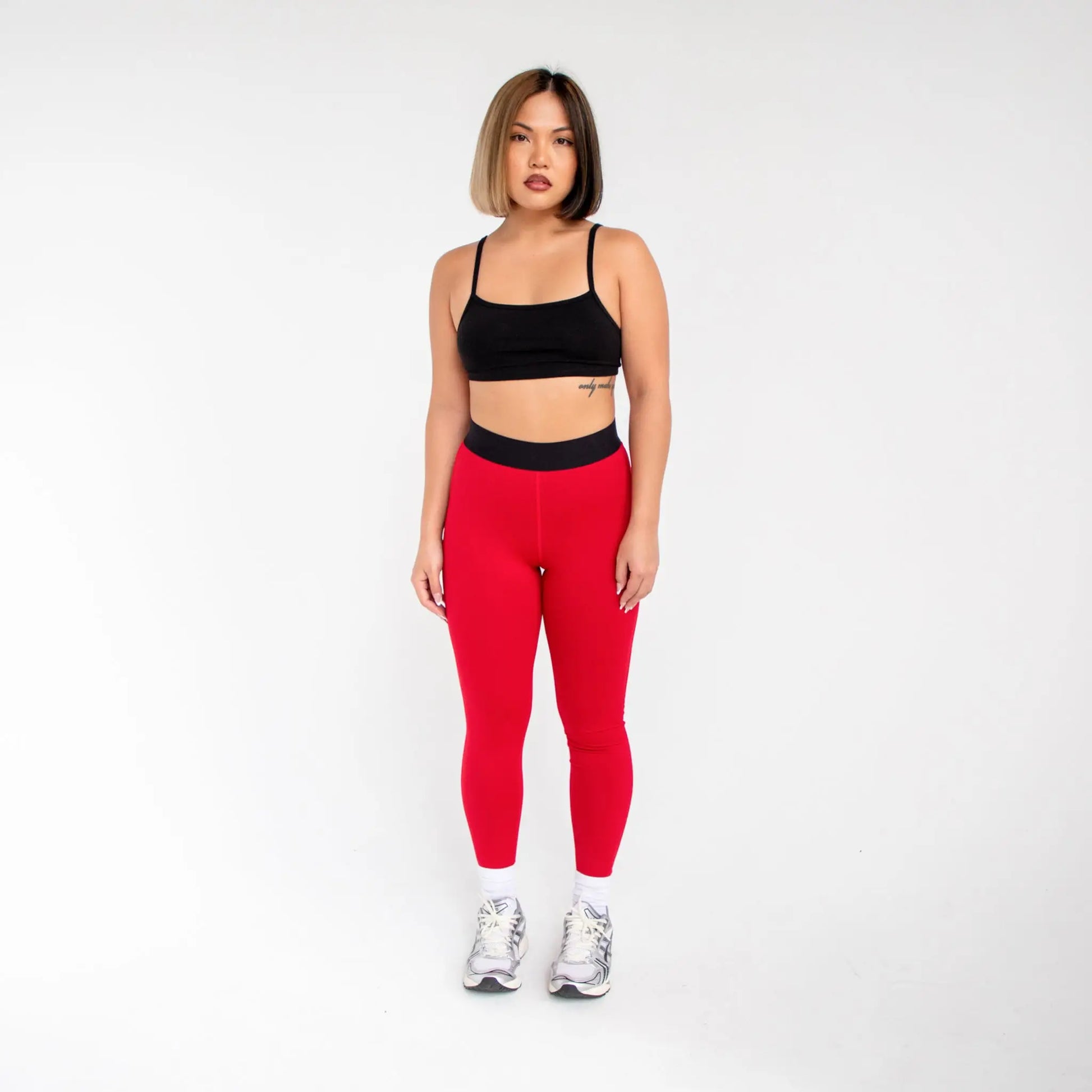 Red leggings with black waistband and white sneakers from 1000BD Women’s Banded Pro Legging info otlapparel