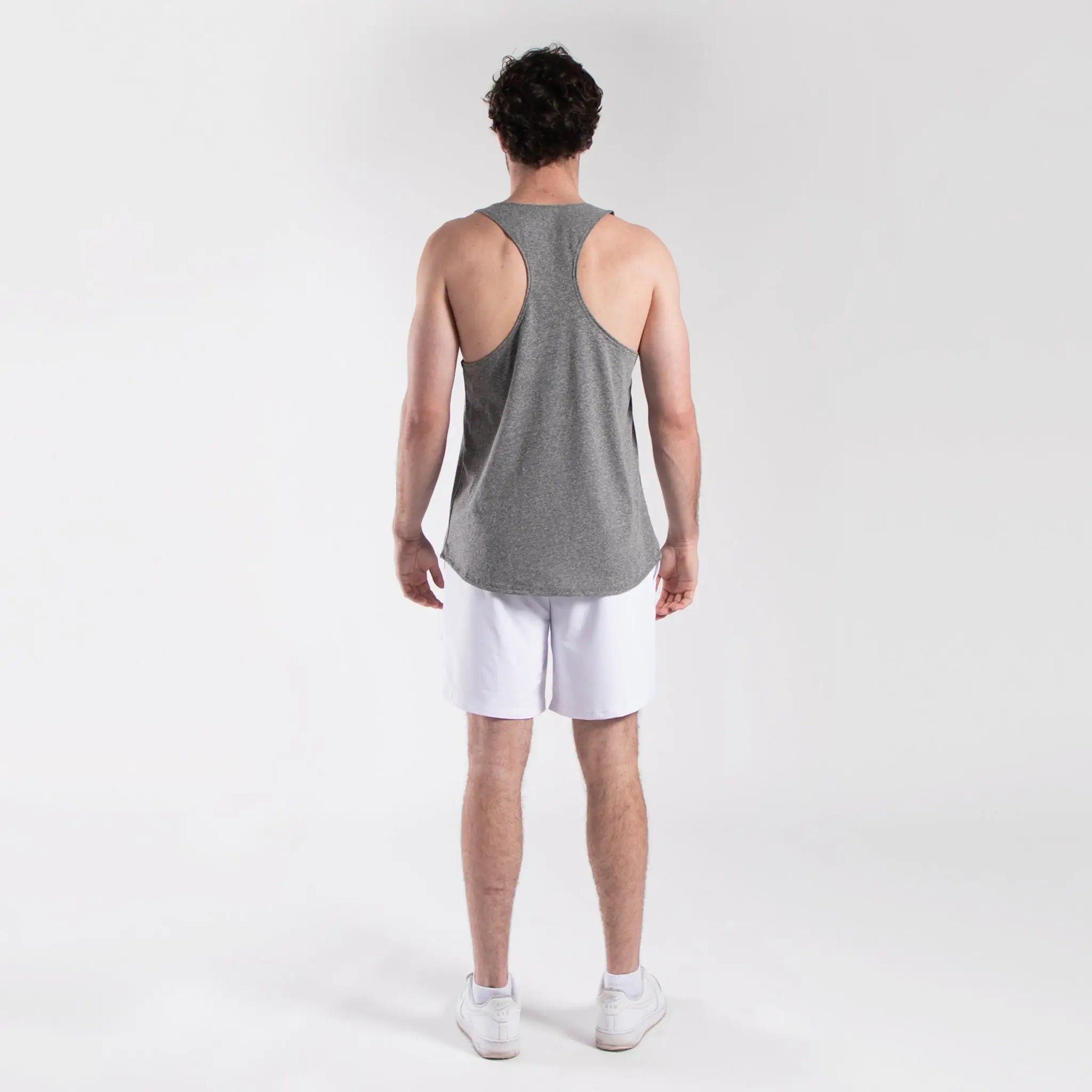 Gray heathered tank top with racerback design paired with Men’s Athletic Shorts