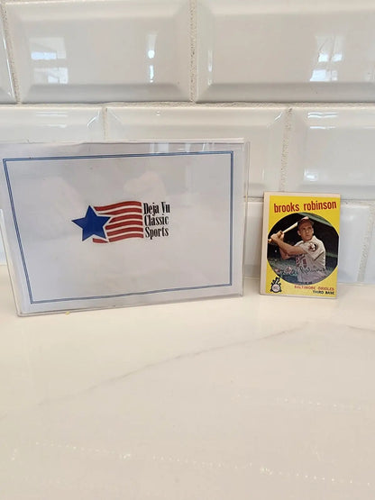 1959 Topps Brooks Robinson trading card with sports memorabilia display