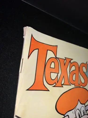 Worn Texas book cover featured in 1963 Texas Longhorns signed program by Darrell Royal