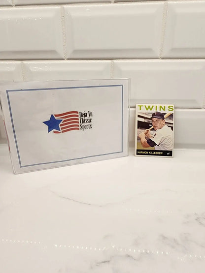 Sports memorabilia featuring the 1964 Topps Harmon Killebrew trading card with iconic design