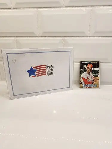 Trading card featuring Lou Brock from the 1967 Topps box showcasing detailed trading card features