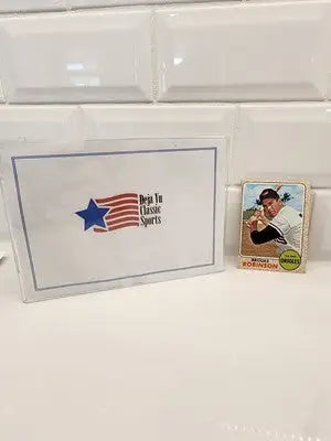Baseball card and protective sleeve featuring 1968 Topps Brooks Robinson #20 collectible