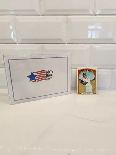 Vintage baseball trading card of Hank Aaron in protective case from 1972 Topps