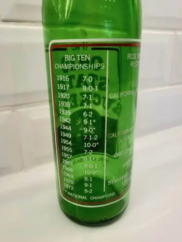Green glass 1973 7UP bottle featuring Ohio State Buckeyes sports statistics