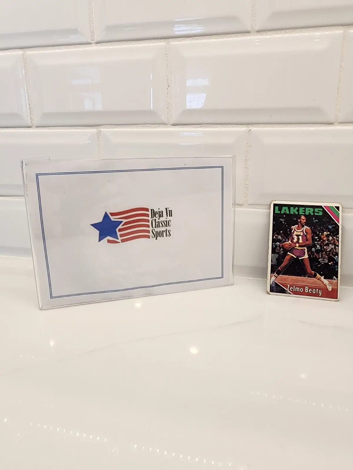 Sports memorabilia display featuring a 1975-76 Topps Zelmo Beaty trading card
