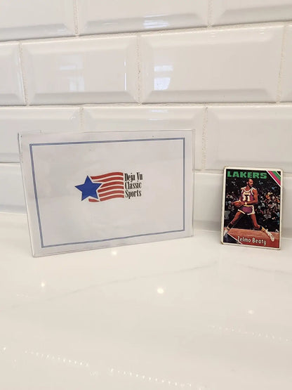 Sports memorabilia display featuring a 1975-76 Topps Zelmo Beaty trading card