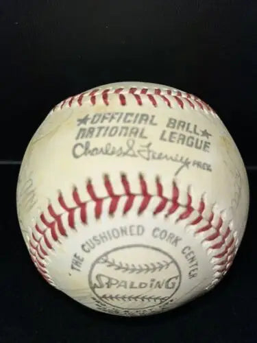 Worn baseball with red stitching, autographed by Dodgers legends including Steve Garvey