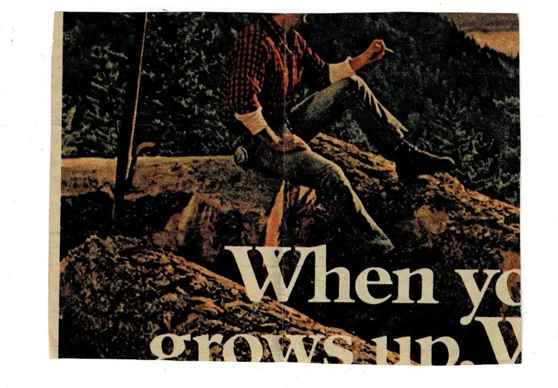 Image of a person in a plaid shirt and jeans sitting on rocks for Mike Barber Houston football card