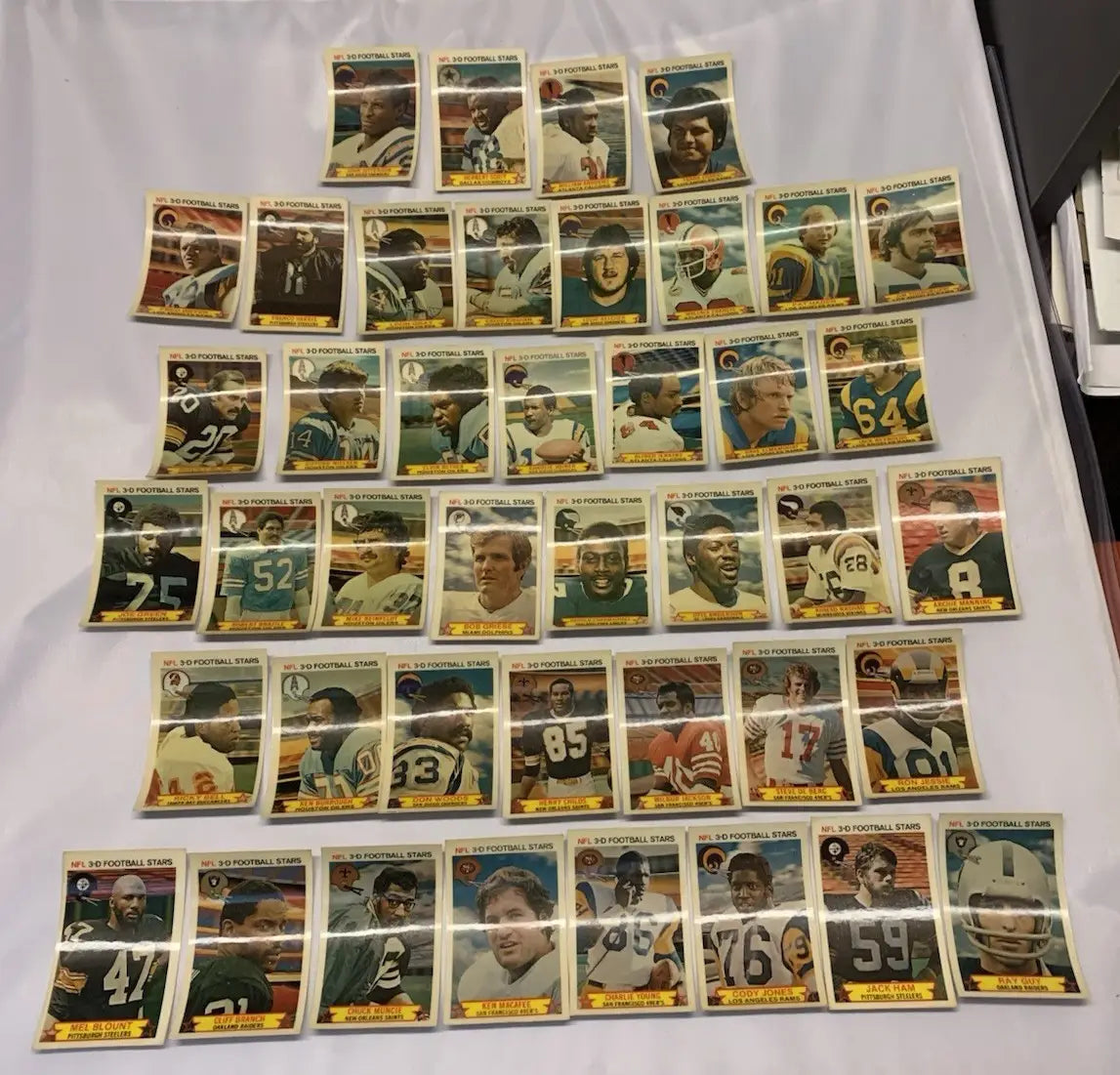 Vintage NFL football stars trading cards from the 1980 Stop N Go 3-D partial card set
