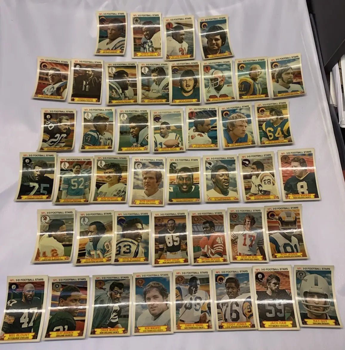 Vintage NFL football stars trading cards from the 1980 Stop N Go 3-D partial card set