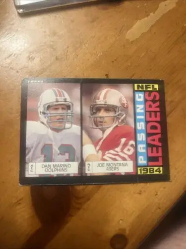 1984 NFL Passing Leaders trading card featuring Joe Montana and Dan Marino in 1985 Topps series