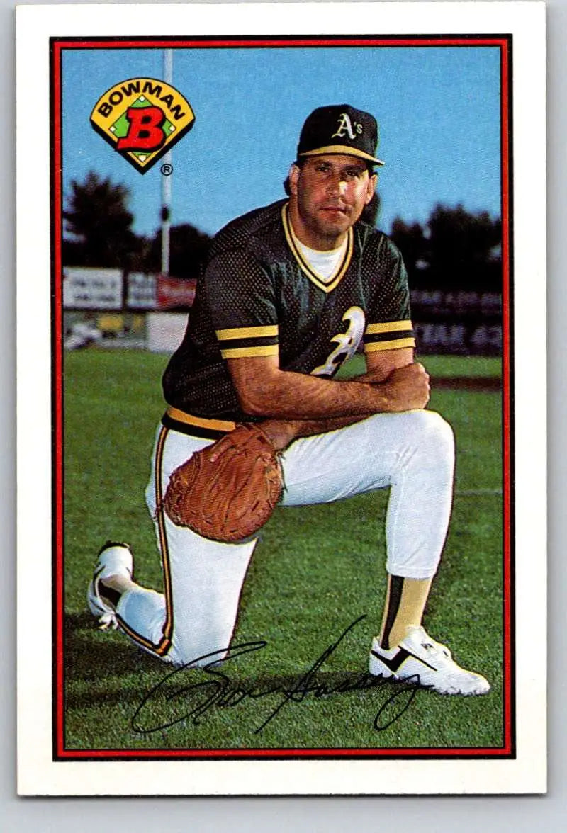 Ron Hassey in Oakland Athletics uniform kneeling with glove, vintage baseball cards