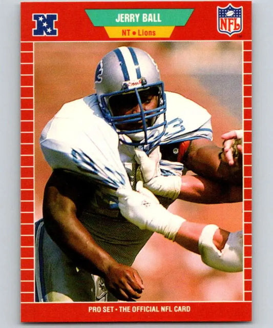 Detroit Lions player Jerry Ball in white jersey carrying football during game action