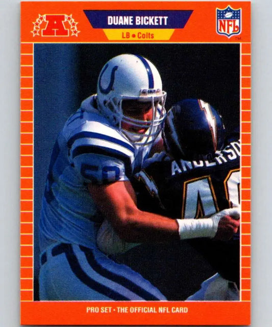 Orange-bordered NFL trading card of Duane Bickett tackling for the Indianapolis Colts