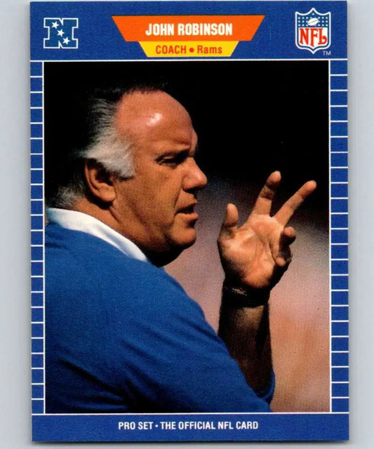 Football coach John Robinson in blue jacket gesturing for Los Angeles Rams card