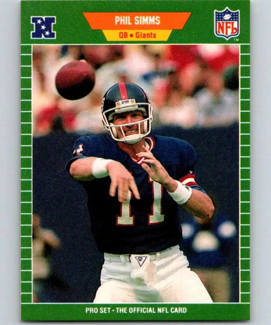 Phil Simms throwing a football in a blue jersey on a New York Giants football card