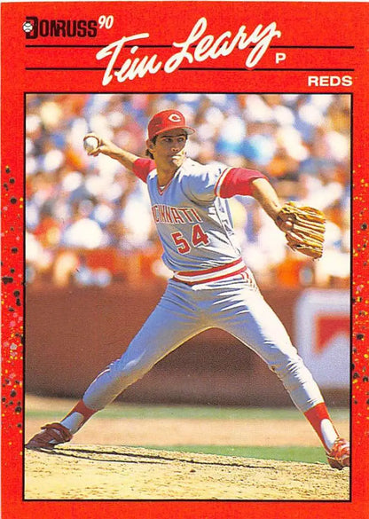 Red 1990 Donruss Tim Leary baseball card showcasing Cincinnati Reds pitcher in delivery