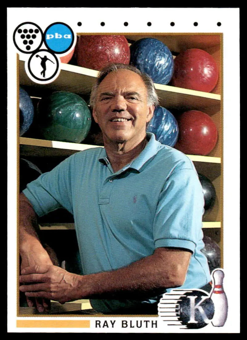 Person in light blue polo shirt next to bowling balls and Ray Bluth PBA Bowling Card