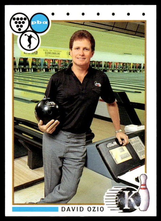 David Ozio in black polo and gray pants with bowling ball on PBA Bowling Card