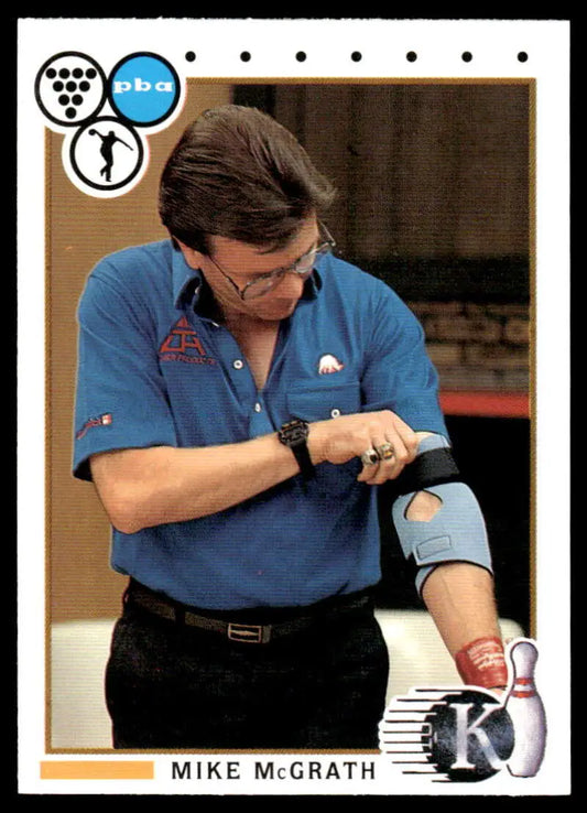 Professional bowler Art Trask in blue polo checking watch on PBA bowling card