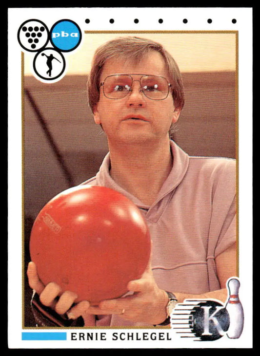 Bright red bowling ball held in front of a light shirt for Ernie Schlegel PBA Bowling Card