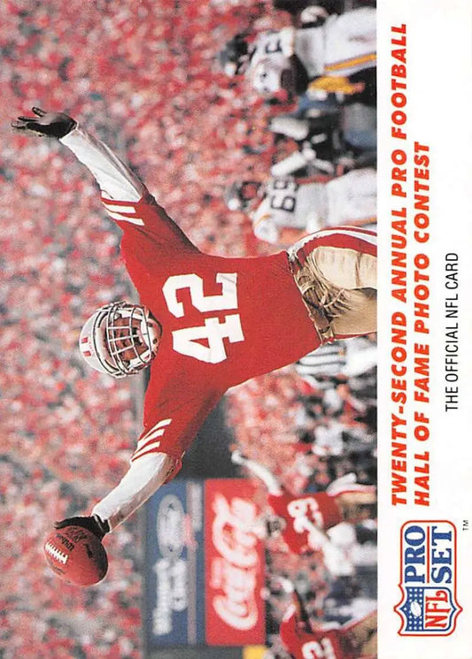 Football player in red #42 jersey diving with ball, showcasing Ronnie Lott of San Francisco 49ers