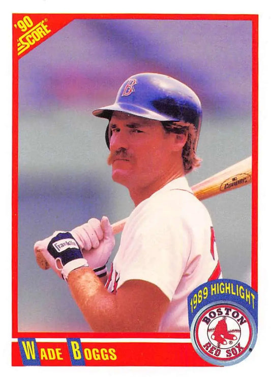 Baseball card of Wade Boggs in a Red Sox white uniform holding a bat