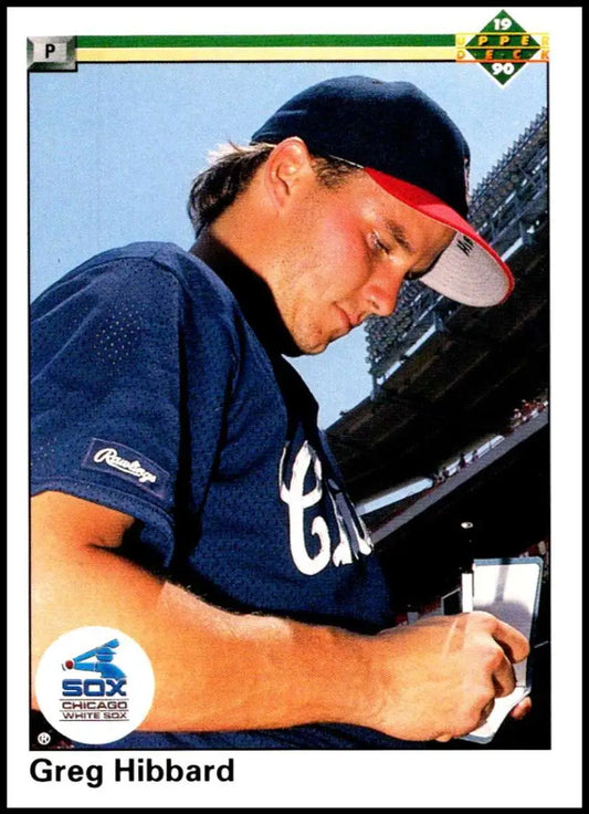 Chicago White Sox player Greg Hibbard signing autographs in navy uniform and cap
