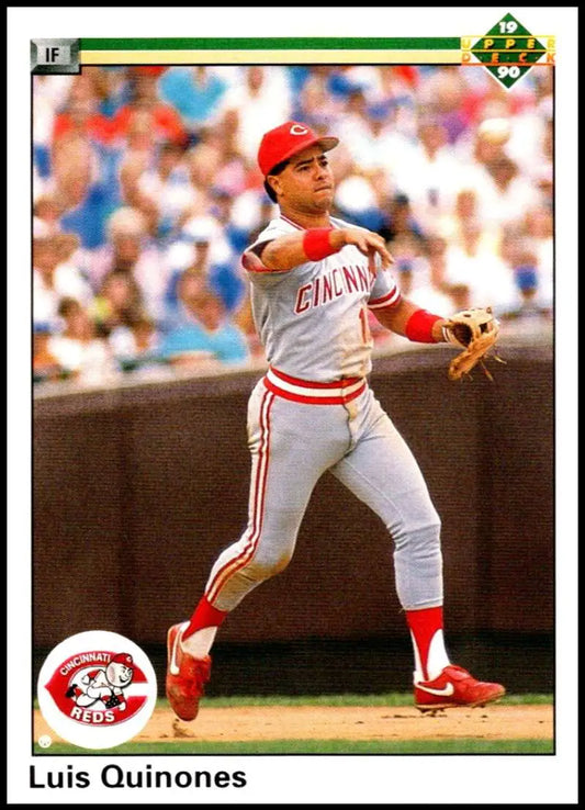Cincinnati Reds player Luis Quinones in white uniform throwing a baseball