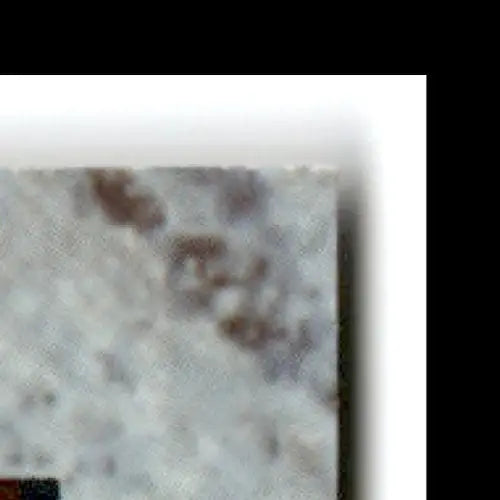 Close-up of speckled light granite tile with reddish-brown inclusions for classic basketball Joe Wylie Miami Hurricanes