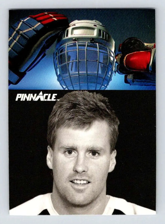 Hockey player in white jersey with gear featured on Toronto Maple Leafs card