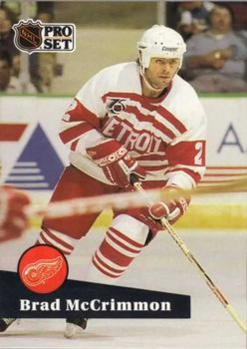 Hockey player in Detroit Red Wings uniform skating with a stick on ice rink