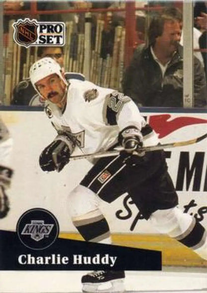 Hockey player in Los Angeles Kings jersey skating, featuring Charlie Huddy card