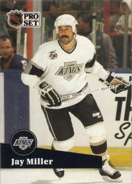 Hockey player in white Los Angeles Kings jersey showcasing Jay Miller during gameplay