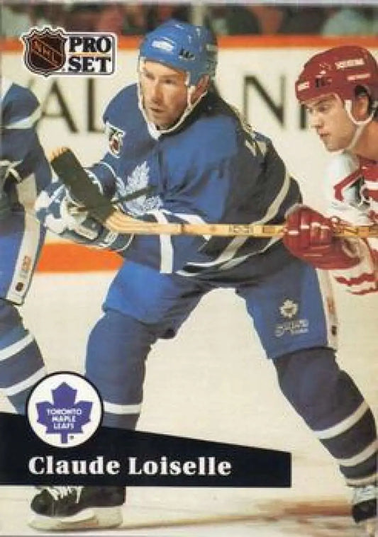 Hockey trading card of Claude Loiselle skating for the Toronto Maple Leafs against an opponent