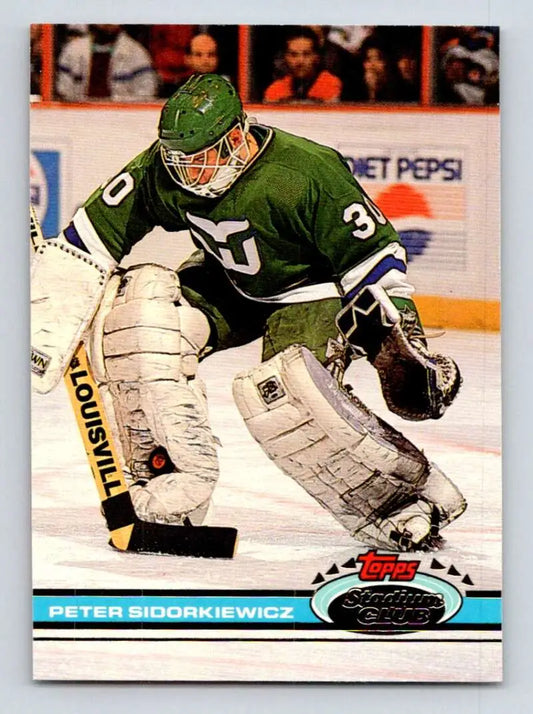 Hockey goalie Peter Sidorkiewicz in green Hartford Whalers jersey makes a save
