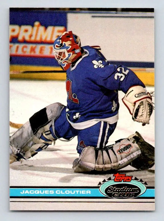 Hockey goalie Jacques Cloutier in Quebec Nordiques jersey making a save during play